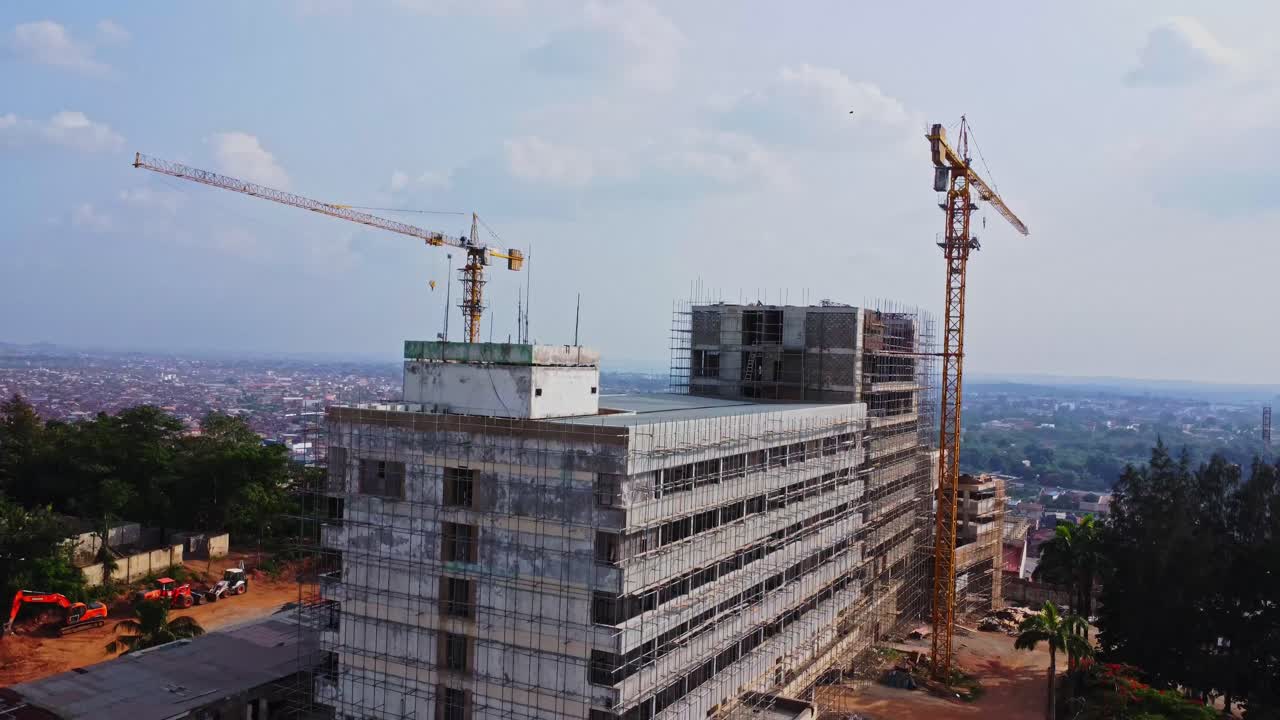 Jib down of a hotel under renovation on a sunny day in Ibadan, Nigeria