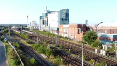 industrial chemical manufacturing factory next to warrington bank quay train tracks rising aerial view
