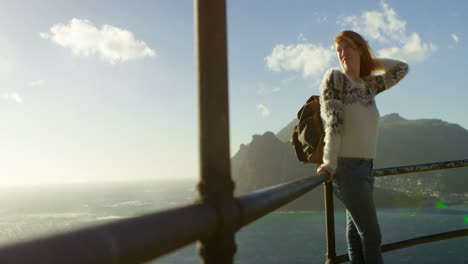 Woman-standing-near-seaside-on-a-sunny-day-4k