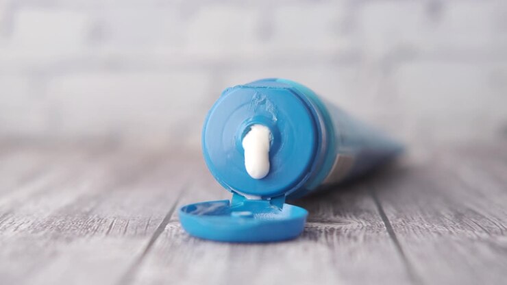 Open tube of blue cosmetic cream