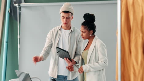 a man and a woman in a studio with a tablet