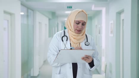 muslim doctor writing medicines for patient