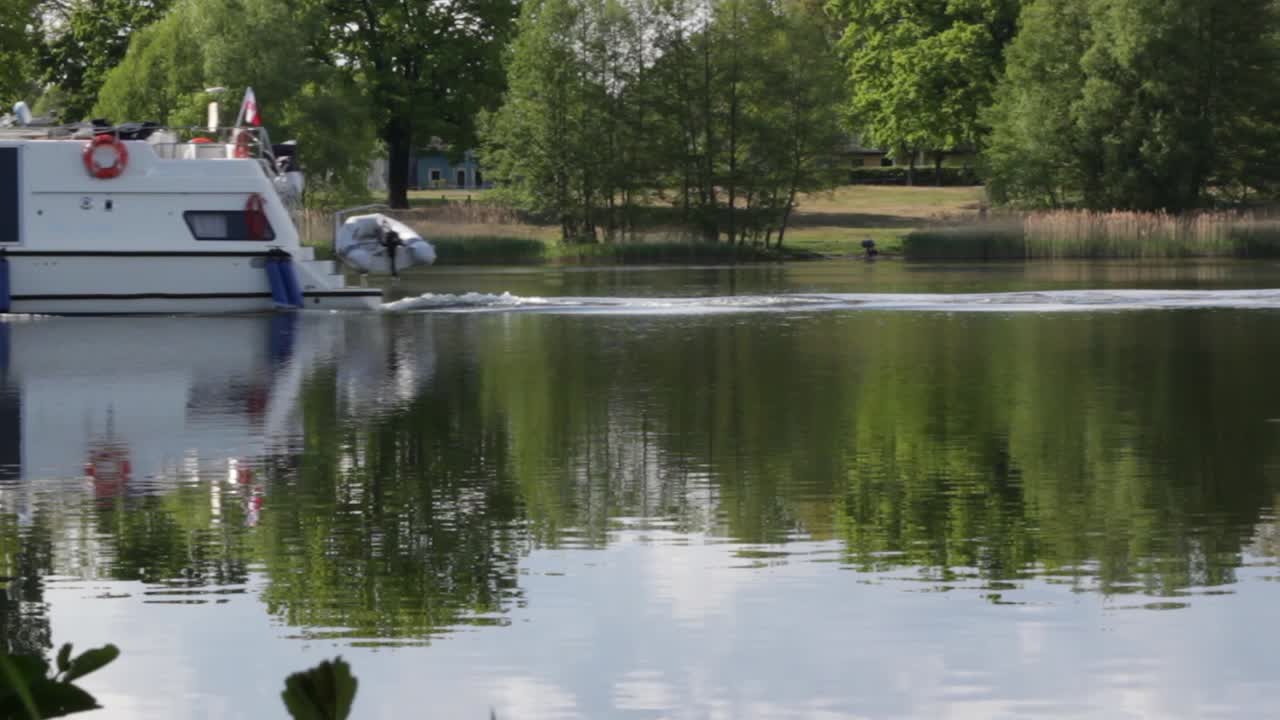White boat goes down the river