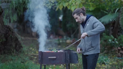 man grilling food outdoors