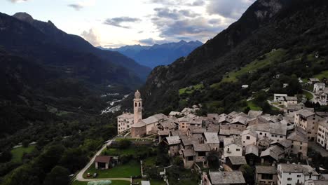 aerial flyover over the historical village of soglio in the bregaglia region of grissons, switzerland with a view of the old church and bregaglia valley