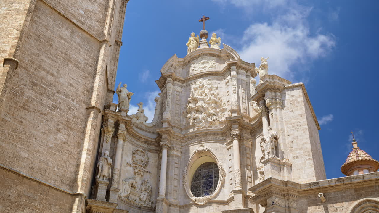 View of the Valencia Cathedral facade and El Miguelete Tower in Spain in daylight