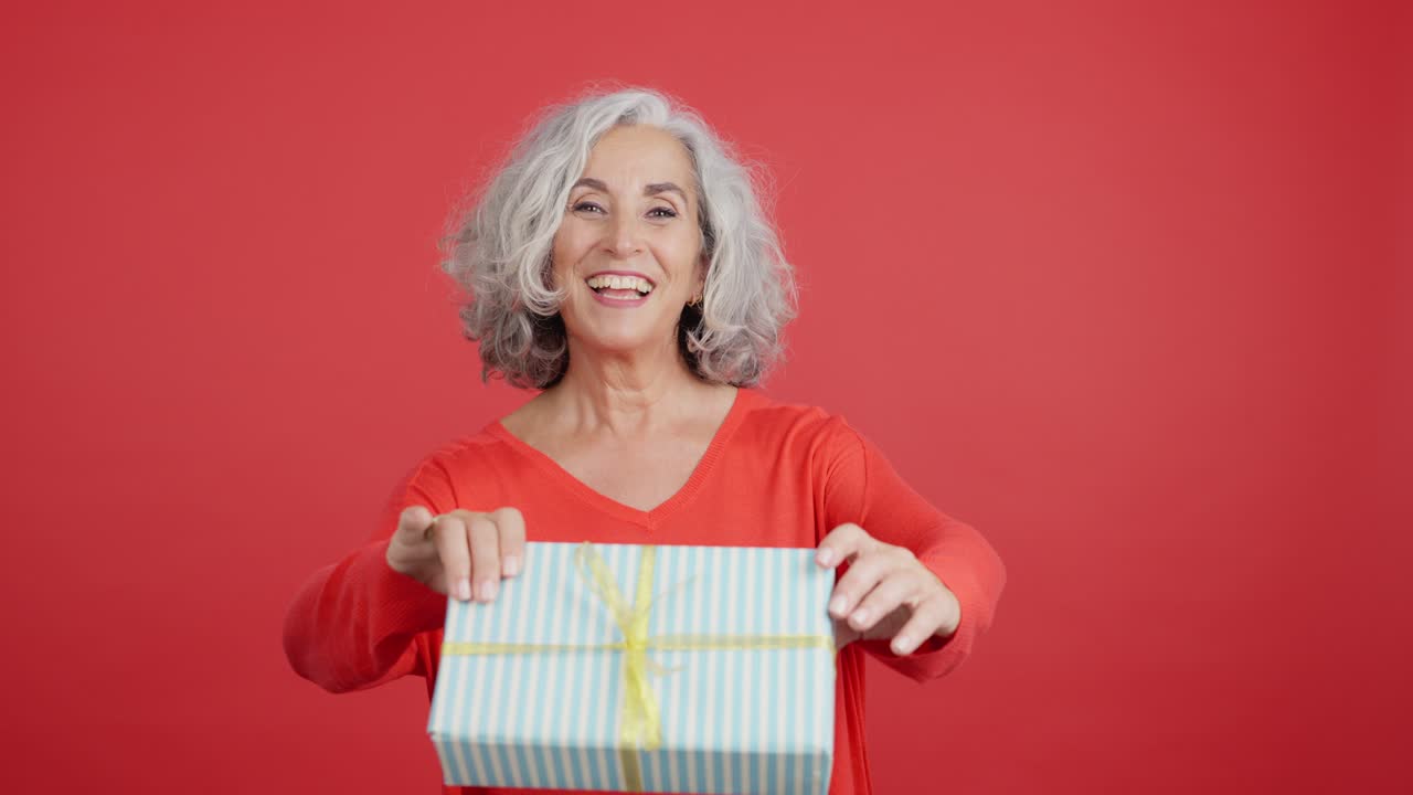 Happy Senior Woman Receiving a Gift