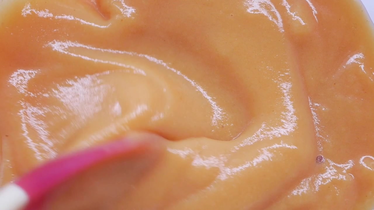 Mixing Smooth Orange Puree with a Silicone Spatula