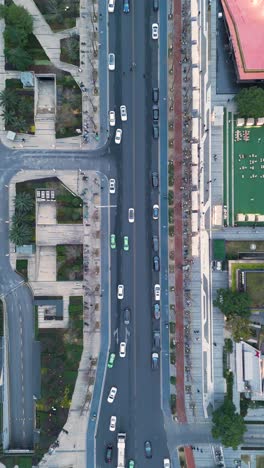 vertical top-down aerial view of a busy intersection in chengdu, china. captures urban traffic flow with vehicles and pedestrian crossings from a dynamic perspective.