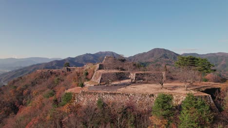 panoramic drone fly above japanese takeda ancient castle ruins, natural travel landscape with fortress