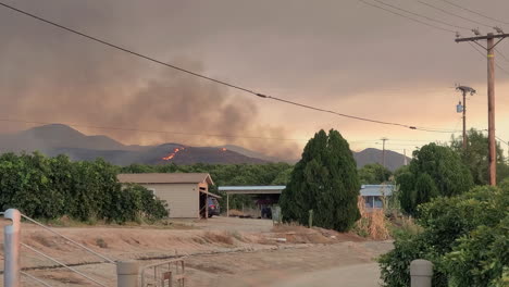 Destructive-and-dangerous-wildfire-Fairview-Fire-burning-on-distant-hills,-Hemet,-California,-USA