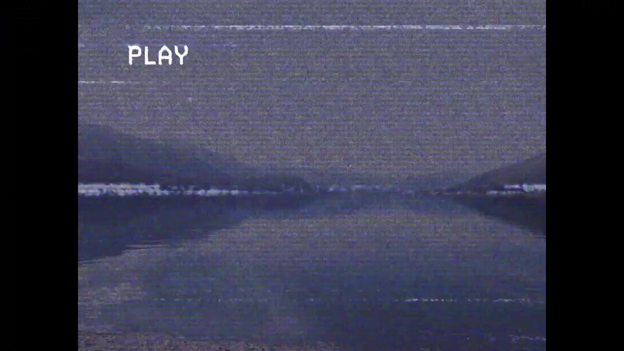 PLAY showing, centered sea showing cresting surf, scanlines flickering, simulating playback