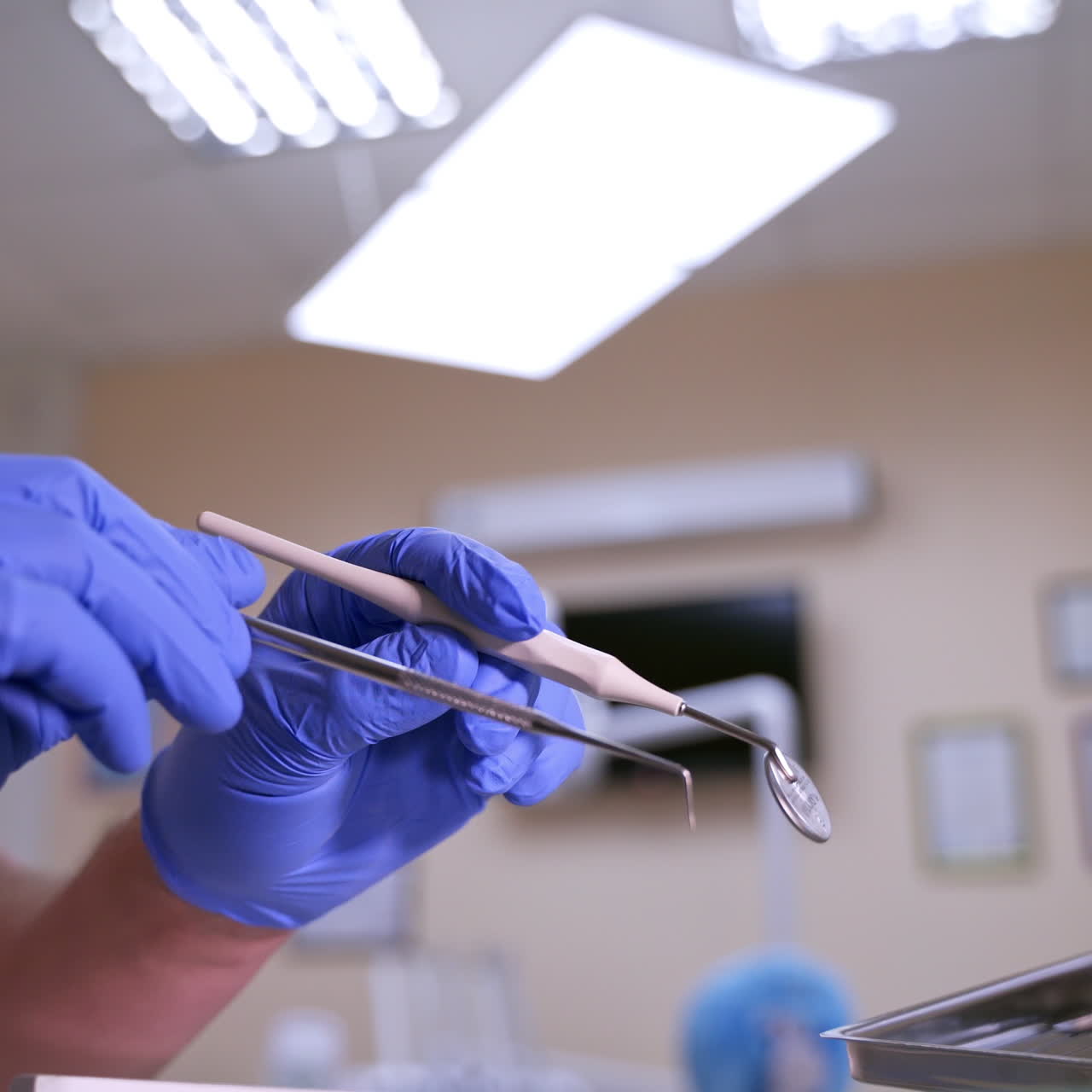 Set of dentist tools on dental cabinet background: dentist mirror, forceps curved, explorer curved, dental explorer angular and explorer curved with chip, right. Dental Hygiene and Health concept video.