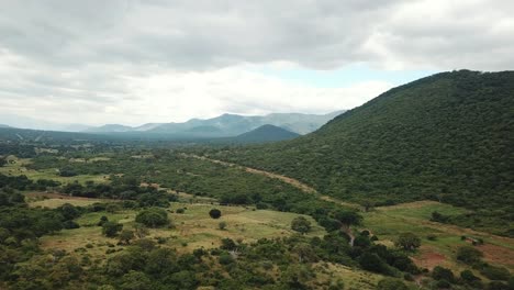 aerial view of the green plains in mountains and trafic road, tanzania, africa