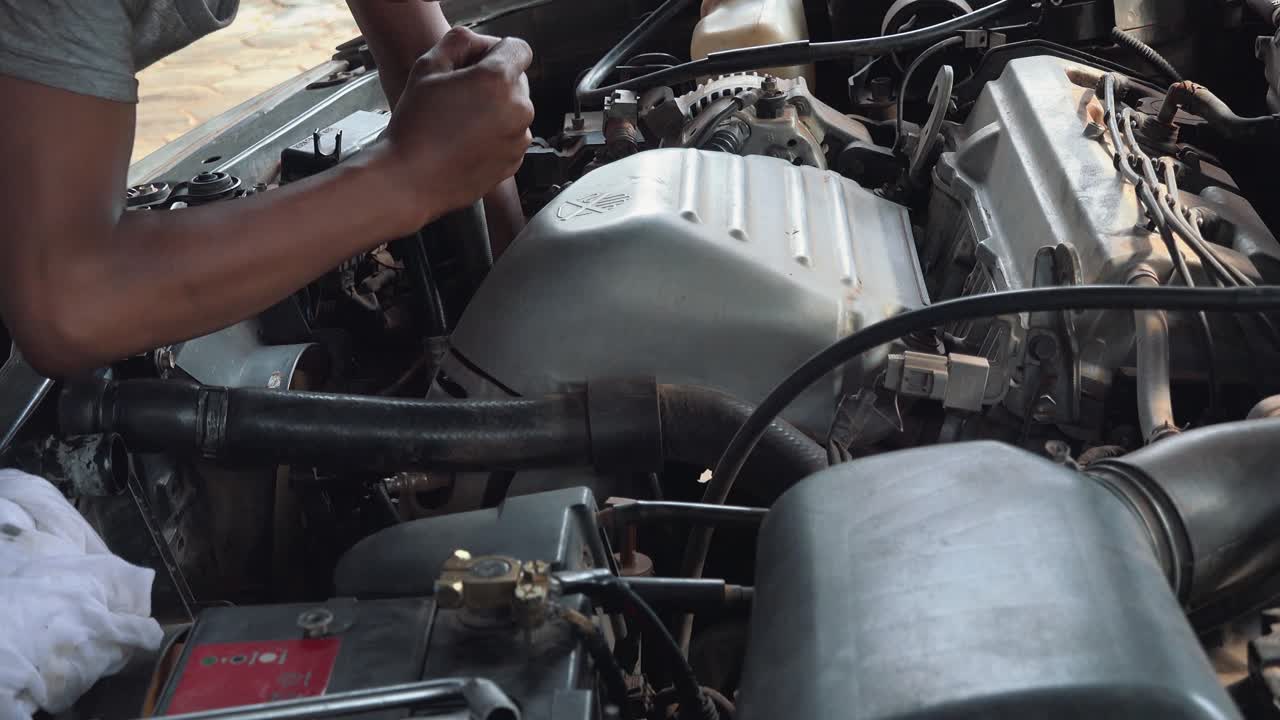 Close Shot of a Mechanic Fixing a Car Engine