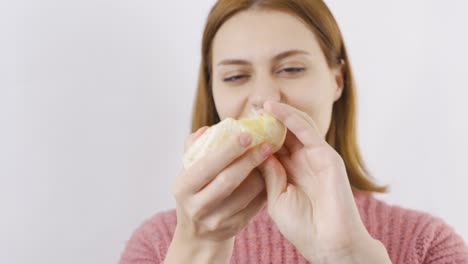 close-up portrait of woman eating orange. eat fruit.