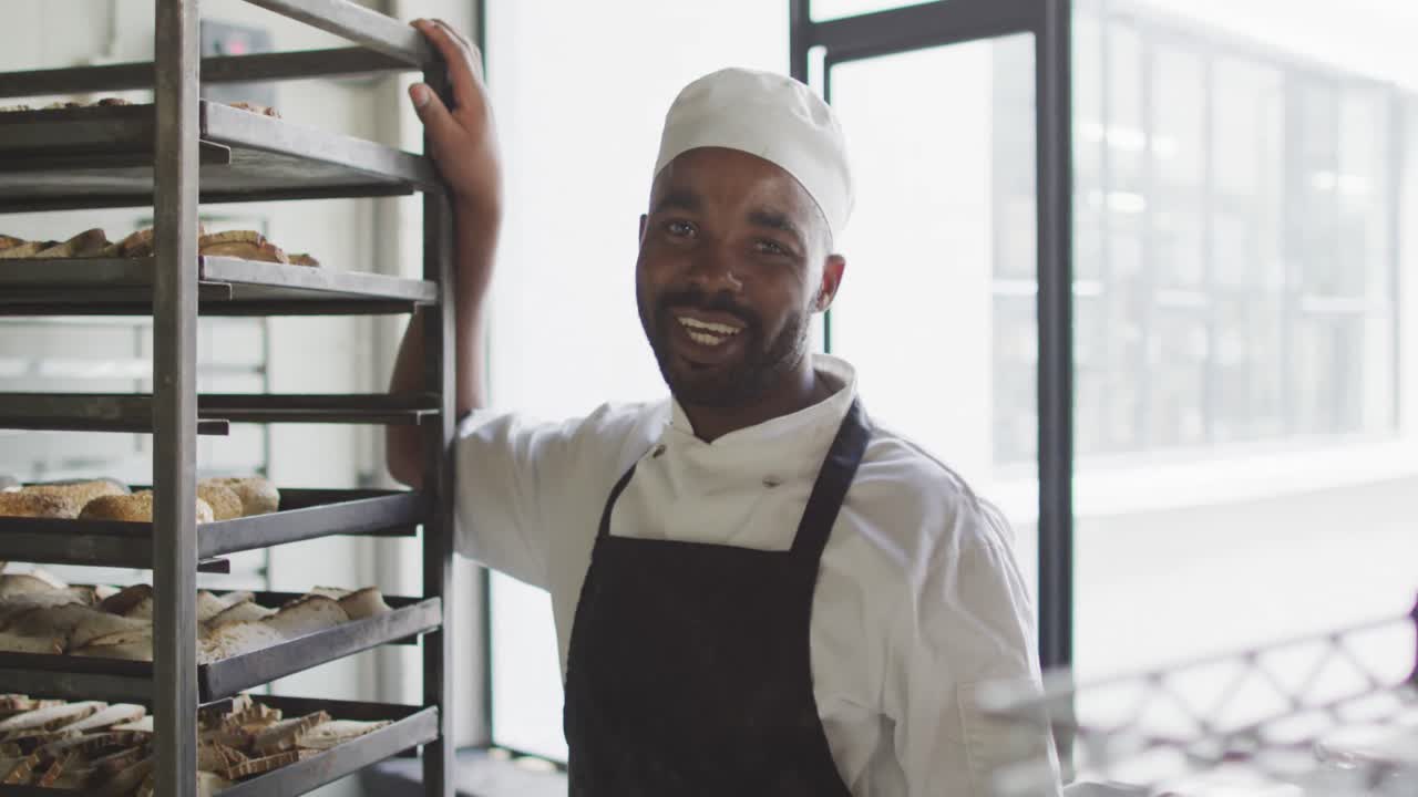 Animation of african american male baker smiling at camera