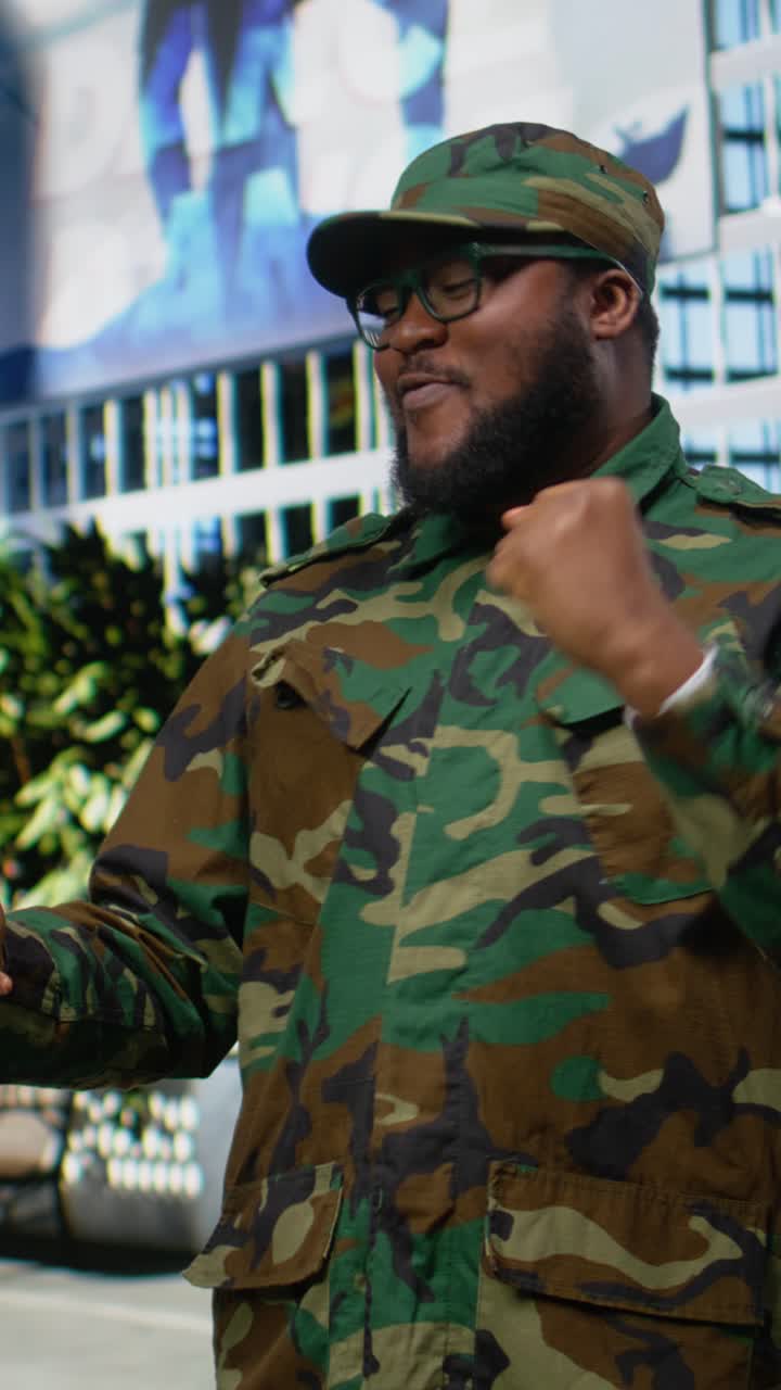 Vertical Video Professional smiling military man reading satisfying good news on mobile phone