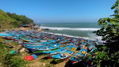 traditional blue indonesian fishing boats on menganti beach, indonesia