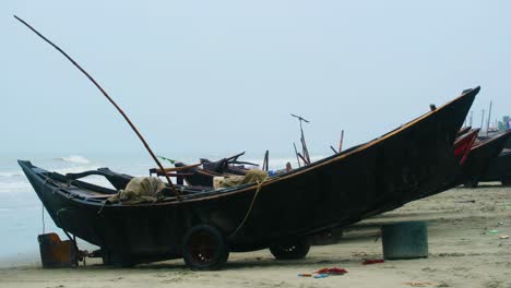 traditional wooden fishing trawler boats at seashore of indian ocean during monsoon season