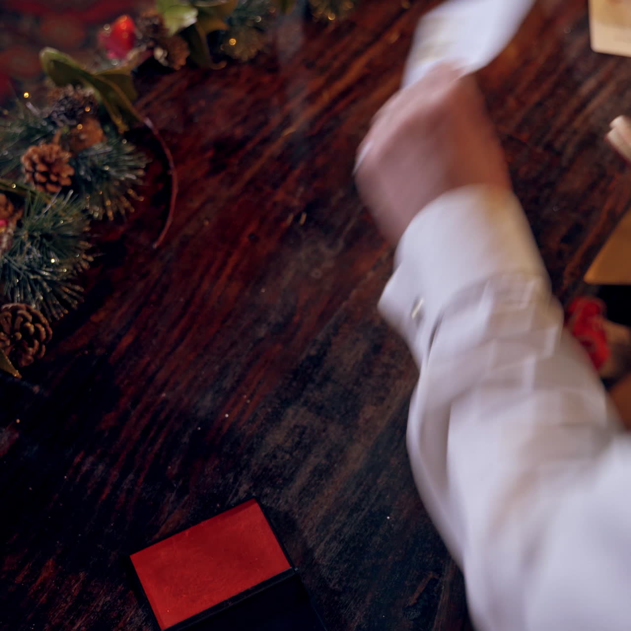 Envelopes for children at Christmas. Elf putting seal on the envelope quickly. Fairy hero making Christmas seal on envelopes.