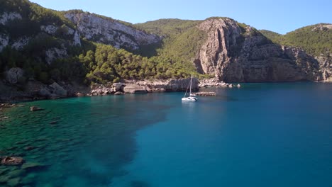 catamaran sailboat anchors in blue lagoon