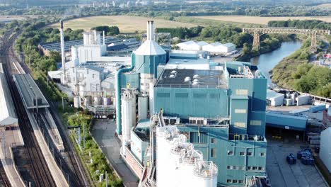 Industrial-chemical-manufacturing-factory-next-to-Warrington-Bank-Quay-train-tracks-aerial-view-orbit-right