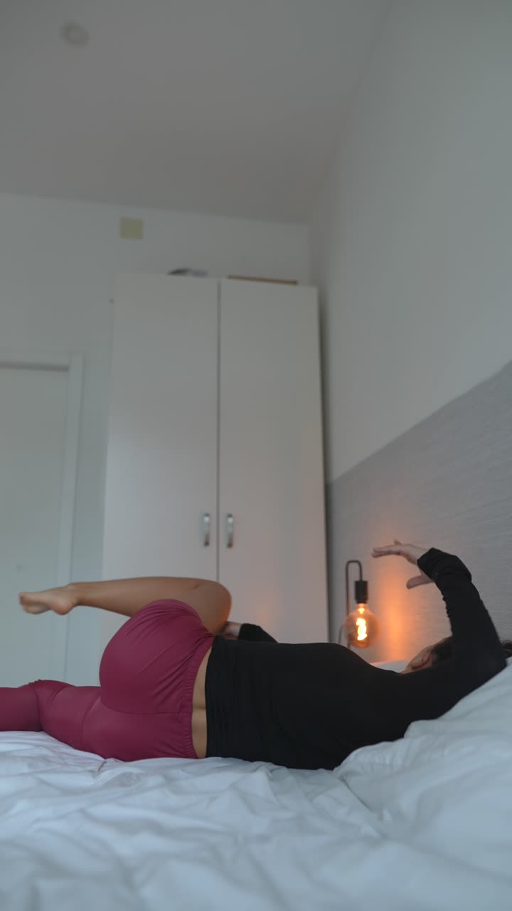 Woman Stretching and Relaxing on Bed