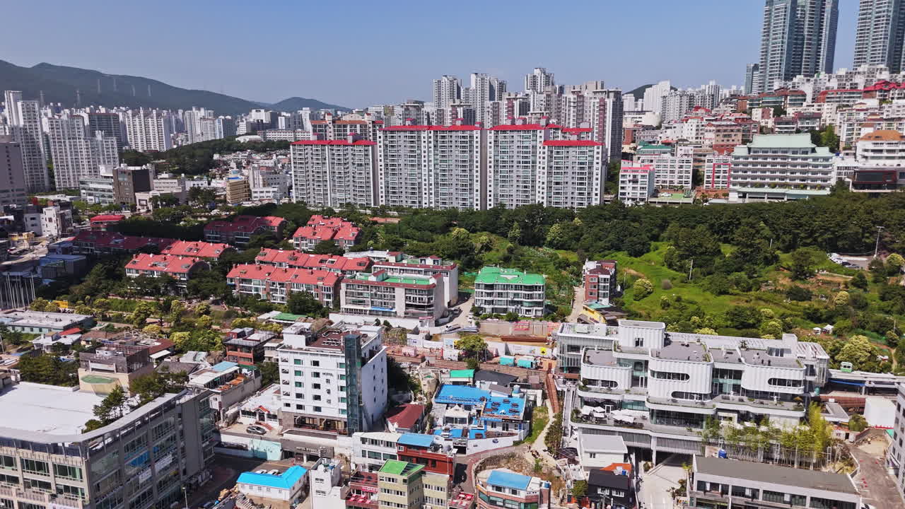 Aerial tilt shot in front of colorful buildings of Mipo, Haeundae, in sunny Busan
