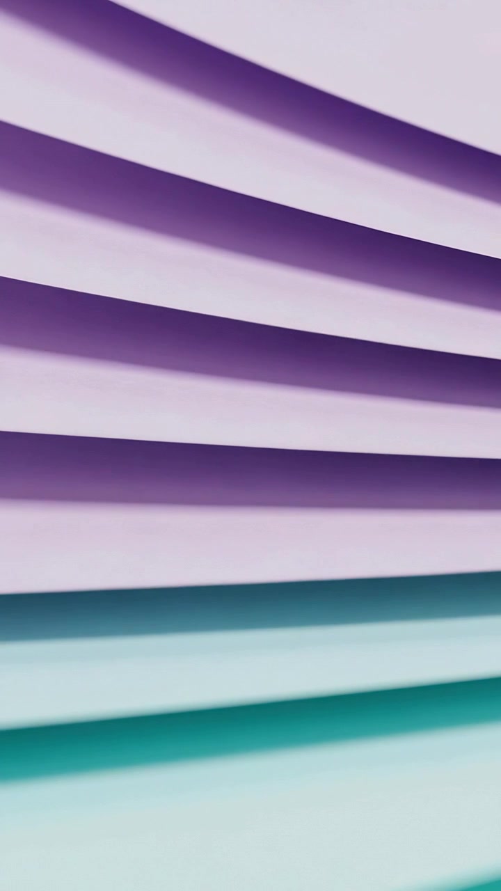 Vertical video: Subtle shift moving pleats showing teal or aqua lower and lavender purple in studio