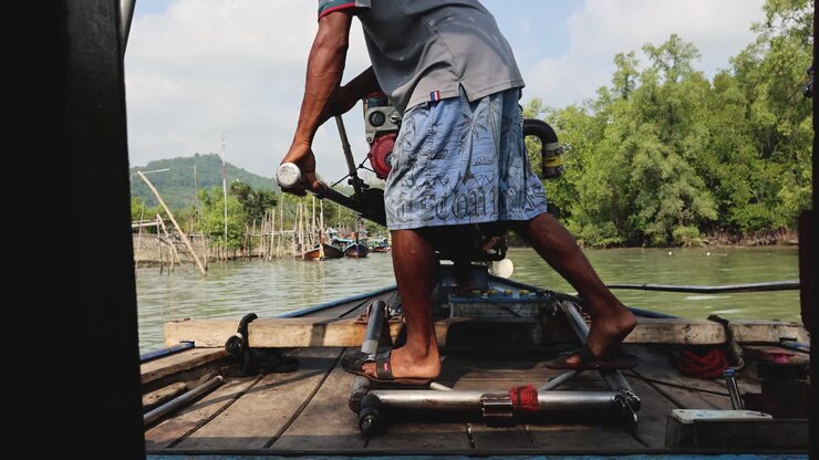 Person pulling starter rope of a boat engine