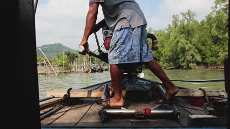 person pulling starter rope of a boat engine