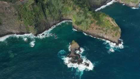 aerial of rugged wild coast of madeira island with beautiful blue water