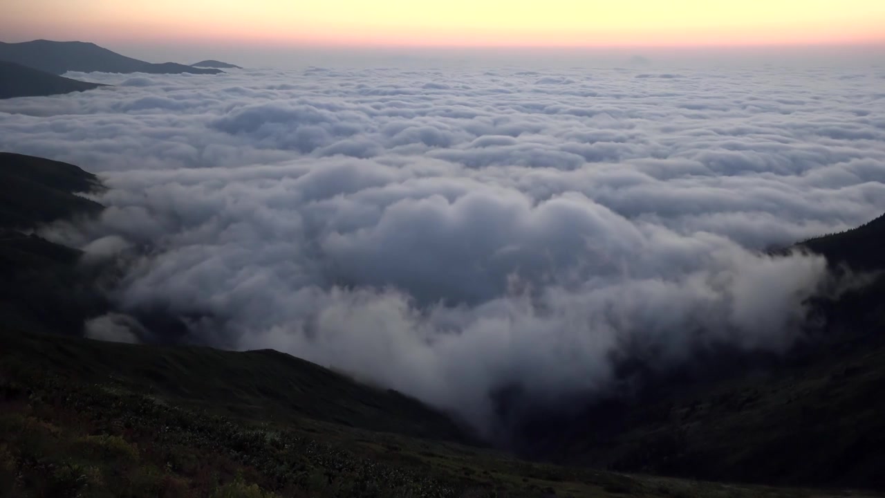 Thick Sea of Clouds Over Mountain Valley at Sunset