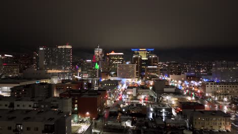 salt lake city, utah skyline at nighttime - aerial push in flyover in december