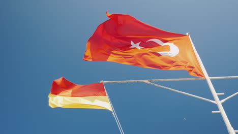 red with crescent turkey flag and rescue service flag against the blue sky beach season in turkey