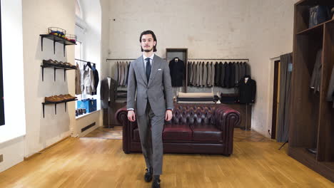 Junger-Herr-Probiert-Einen-Grauen-Anzug-In-Einem-Luxuriösen,-Eleganten-Boutique-Shop-An