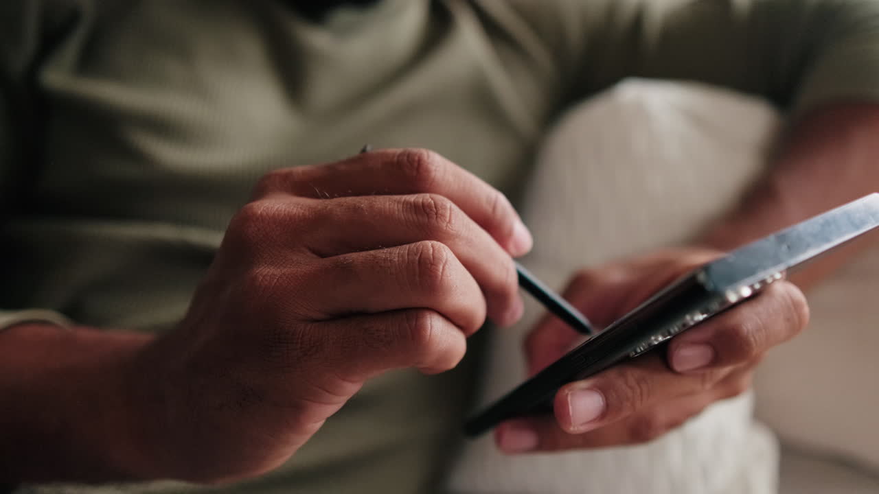 Couple At Home: Man Using Phone Stylus