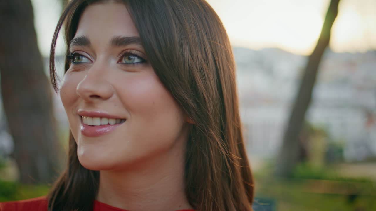 Woman posing sunset greenery background portrait. Happy girl looking camera