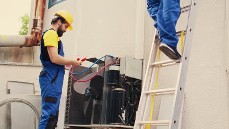 expert and coworker servicing condenser