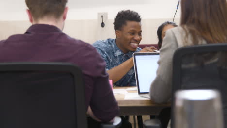 Male-And-Female-Colleagues-Smiling-Together-In-Office