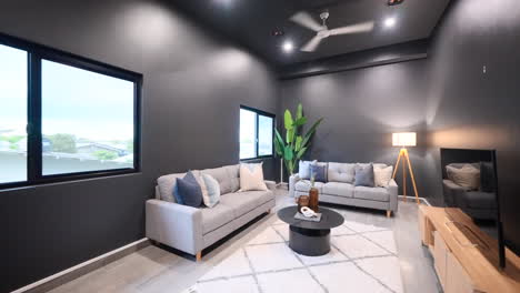 interior designed moody stylish contemporary modern luxurious cinema media room or small lounge entertainment room with dark grey walls modern furniture