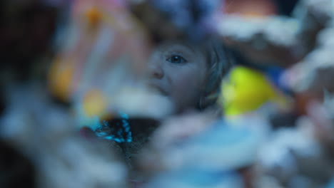 little-girl-looking-at-fish-in-aquarium-curious-child-watching-colorful-sea-life-swimming-in-tank-learning-about-marine-animals-in-underwater-ecosystem-inquisitive-kid-at-oceanarium