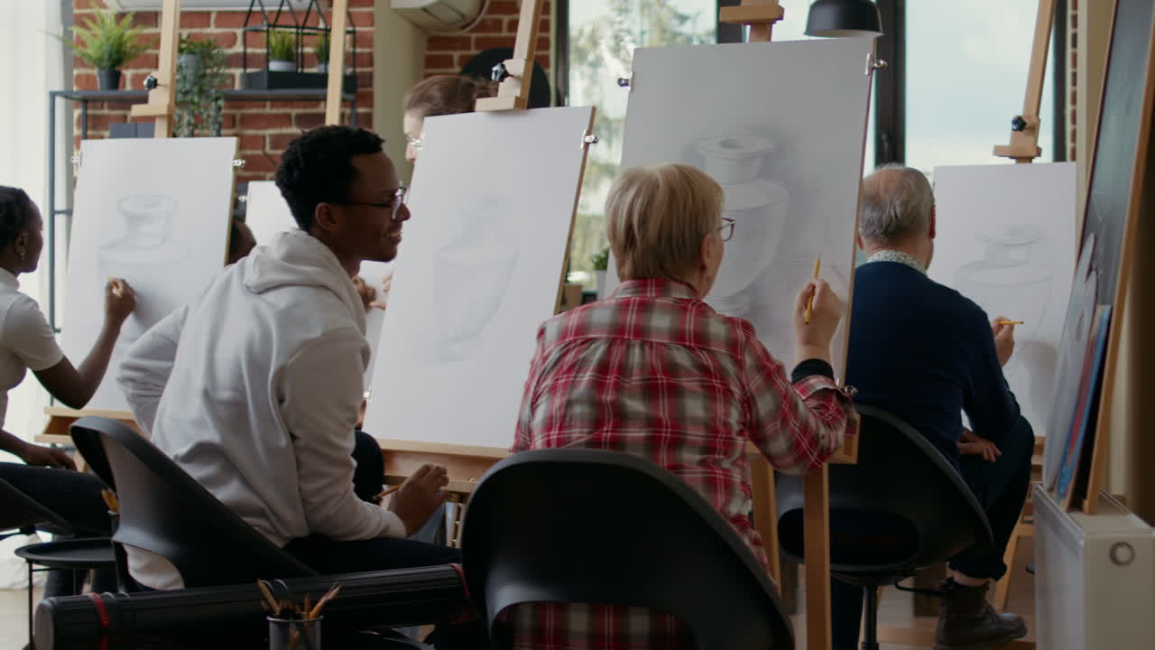 Elder woman and young man learning to draw sketch on canvas