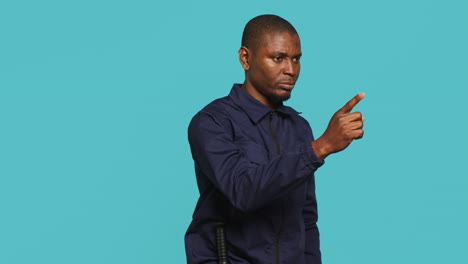 portrait of security agent pointing finger at people, warning them