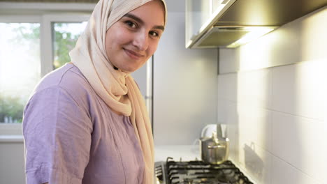 islamic woman wearing hiyab in the kitchen.