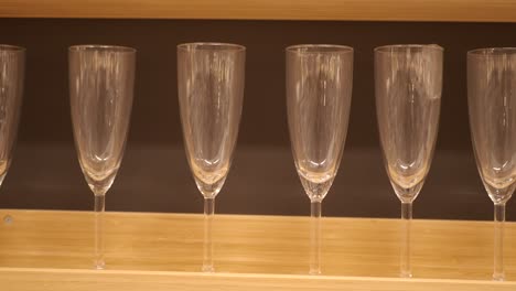 empty champagne glasses on wooden shelf