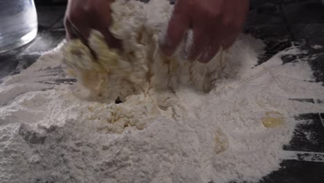 chef kneading preparation with flour and water