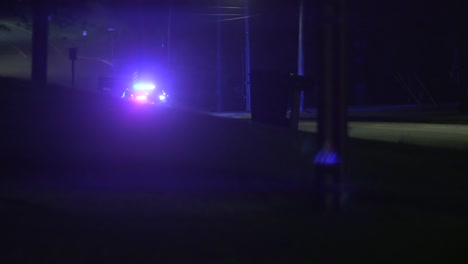 flashing police car lights at a traffic stop