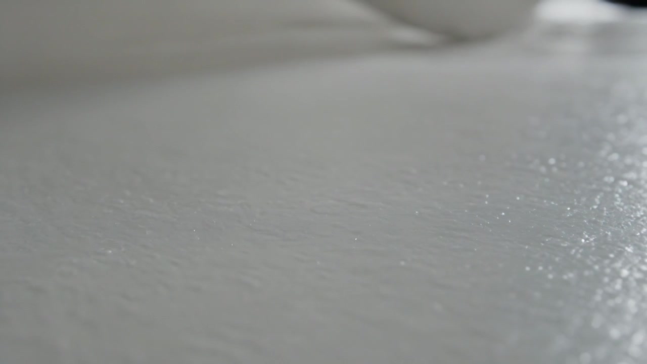 Adjusting camera focus reducing grain, softening white surface on countertop showing bowl rim gleam